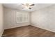 Clean bedroom features light colored walls, hardwood floors, and a ceiling fan at 4436 E Shomi St, Phoenix, AZ 85044