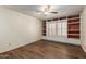 Bright room with hard wood floor and built-in shelving surrounding a window at 4436 E Shomi St, Phoenix, AZ 85044