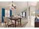 Open dining room flows to living area with vaulted ceiling and bright natural light at 4436 E Shomi St, Phoenix, AZ 85044