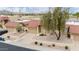 Aerial view of single-story home with red tile roof, desert landscaping, and view of community lake at 4436 E Shomi St, Phoenix, AZ 85044