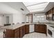 Well-lit kitchen with breakfast bar, stainless steel appliances, and granite countertops at 4436 E Shomi St, Phoenix, AZ 85044