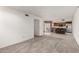 Bright and airy living space with neutral carpet leading to the kitchen with stainless steel appliances at 4436 E Shomi St, Phoenix, AZ 85044