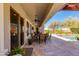 Covered back patio with outdoor dining set overlooking the pool at 5414 E Palo Brea Ln, Cave Creek, AZ 85331