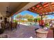 Beautiful back patio with dining area, built-in grill, and view of the refreshing pool at 5414 E Palo Brea Ln, Cave Creek, AZ 85331