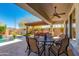 Inviting back patio with built-in barbeque, dining set, and view of the sparkling pool at 5414 E Palo Brea Ln, Cave Creek, AZ 85331