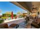Stunning covered patio offering a seating area, beautiful pool, and lush landscaping at 5414 E Palo Brea Ln, Cave Creek, AZ 85331
