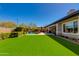 Lush backyard with green artificial turf, pool, and patio seating, creating a serene outdoor living space at 5414 E Palo Brea Ln, Cave Creek, AZ 85331