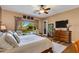 Bright main bedroom featuring a king bed, wooden dresser, and a view of the outdoor space and pool area at 5414 E Palo Brea Ln, Cave Creek, AZ 85331