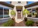 Charming home's entry featuring a decorative door, potted plants, and a welcoming doormat at 5414 E Palo Brea Ln, Cave Creek, AZ 85331