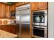 Close up of kitchen appliances, including stainless refrigerator and double oven at 5414 E Palo Brea Ln, Cave Creek, AZ 85331