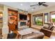 Inviting living room features a stone fireplace and built-in cabinets at 5414 E Palo Brea Ln, Cave Creek, AZ 85331