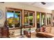 Bright living room with views of the desert landscape and updated fixtures at 5414 E Palo Brea Ln, Cave Creek, AZ 85331
