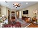 Spacious living room with hardwood floors, comfortable seating, ceiling fan and large media cabinet at 5414 E Palo Brea Ln, Cave Creek, AZ 85331