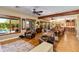 Spacious living room boasts wood beams, windows and hardwood floors at 5414 E Palo Brea Ln, Cave Creek, AZ 85331