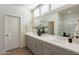 Bright bathroom with double sinks, a large mirror, and a window providing plenty of natural light at 560 W Copper Way, Chandler, AZ 85225