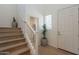 Bright entryway featuring hardwood floors, a staircase, and a view into the adjacent room at 560 W Copper Way, Chandler, AZ 85225