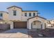 Stylish two-story home with a brown garage door and an inviting arched entryway, complemented by well-maintained landscaping at 560 W Copper Way, Chandler, AZ 85225