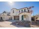 Beautiful two-story home with a brown garage door, an arched entryway, and modern landscaping at 560 W Copper Way, Chandler, AZ 85225