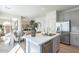 Well-lit kitchen boasts stainless steel appliances, a kitchen island, and seamless flow into the dining area at 560 W Copper Way, Chandler, AZ 85225
