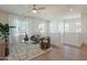 Bright living room features neutral decor, a ceiling fan, and comfortable seating, plus natural light from the windows at 560 W Copper Way, Chandler, AZ 85225