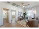 Cozy living room with a ceiling fan, neutral decor, and a view into the connected bathroom at 560 W Copper Way, Chandler, AZ 85225