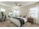 Serene primary bedroom with soft lighting, a neutral color palette, ceiling fan, and large windows at 560 W Copper Way, Chandler, AZ 85225