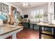 Bright art studio with ample natural light, featuring multiple workstations, easels, and artwork at 579 E Mary Ct, Gilbert, AZ 85295