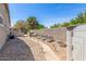 Low-maintenance backyard with a decorative rock landscape, charming pathway, and a storage shed for added convenience at 579 E Mary Ct, Gilbert, AZ 85295