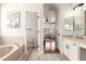 Bathroom with a soaking tub and an open doorway leading to the primary bedroom at 579 E Mary Ct, Gilbert, AZ 85295