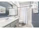 Clean bathroom featuring a single vanity with a mirror, a toilet, and a shower with a white shower curtain at 579 E Mary Ct, Gilbert, AZ 85295