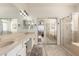Bathroom featuring dual sinks, mirrors, a shower, and a glimpse of the bedroom at 579 E Mary Ct, Gilbert, AZ 85295