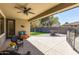 Comfortable covered patio featuring wicker furniture, ceiling fan, and views of the backyard and lawn at 579 E Mary Ct, Gilbert, AZ 85295