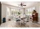 Bright dining area with bay window, white plantation shutters, wood table, and unique decor at 579 E Mary Ct, Gilbert, AZ 85295