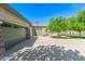 Home exterior with a three-car garage, inviting patio, and mature landscaping at 579 E Mary Ct, Gilbert, AZ 85295