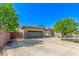 Inviting home featuring a three-car garage, a well-manicured yard, and attractive stone accents at 579 E Mary Ct, Gilbert, AZ 85295