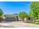 Beautiful home with a spacious driveway, a well-maintained lawn, and mature trees providing shade at 579 E Mary Ct, Gilbert, AZ 85295