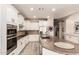 Modern kitchen with stainless appliances, granite counters, white cabinets, and a large island at 579 E Mary Ct, Gilbert, AZ 85295