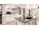Open-concept kitchen with large island, granite countertops, dual sink, and white cabinetry at 579 E Mary Ct, Gilbert, AZ 85295