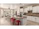 Modern kitchen with large island, breakfast bar, stainless appliances, and open layout at 579 E Mary Ct, Gilbert, AZ 85295
