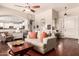 Cozy living room with hardwood floors, comfortable seating, and view into the kitchen at 579 E Mary Ct, Gilbert, AZ 85295