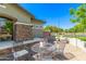 Inviting outdoor patio with stone pillars, wrought iron furniture and well-maintained landscaping at 579 E Mary Ct, Gilbert, AZ 85295