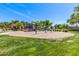 Community playground featuring swings, slides, and a play structure surrounded by lush greenery and open space at 579 E Mary Ct, Gilbert, AZ 85295