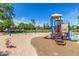 Community playground featuring swings and a slide for outdoor recreation, surrounded by a lush green landscape at 579 E Mary Ct, Gilbert, AZ 85295
