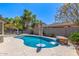Sparkling pool showcasing a waterfall feature and ample patio space for outdoor enjoyment, perfect for relaxation and entertainment at 579 E Mary Ct, Gilbert, AZ 85295