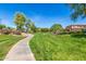 Scenic community walking path through a lush green park, offering a peaceful environment for exercise and outdoor enjoyment at 579 E Mary Ct, Gilbert, AZ 85295