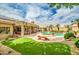 Expansive backyard with pool, spa, putting green, and outdoor kitchen; perfect for entertaining and relaxation at 6158 W Donald Dr, Glendale, AZ 85310
