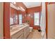 Bathroom with dual sinks, large mirror, and bright light fixtures at 6158 W Donald Dr, Glendale, AZ 85310
