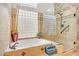Bathroom with glass shower, soaking tub, and tiled surround at 6158 W Donald Dr, Glendale, AZ 85310