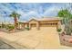 Beautiful home featuring a three-car garage, stone accents, tile roof, and mature landscaping at 6158 W Donald Dr, Glendale, AZ 85310