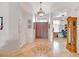 Inviting foyer featuring decorative tile flooring, high ceilings, and a grand wooden entrance door at 6158 W Donald Dr, Glendale, AZ 85310